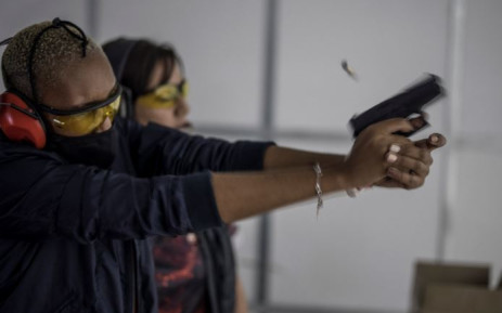 A spent shell leaves a pistol fired by a woman as she takes part in training organised by the women empowerment group Girls on Fire, in Midrand, on 7 February 2021. Picture: MARCO LONGARI/AFP